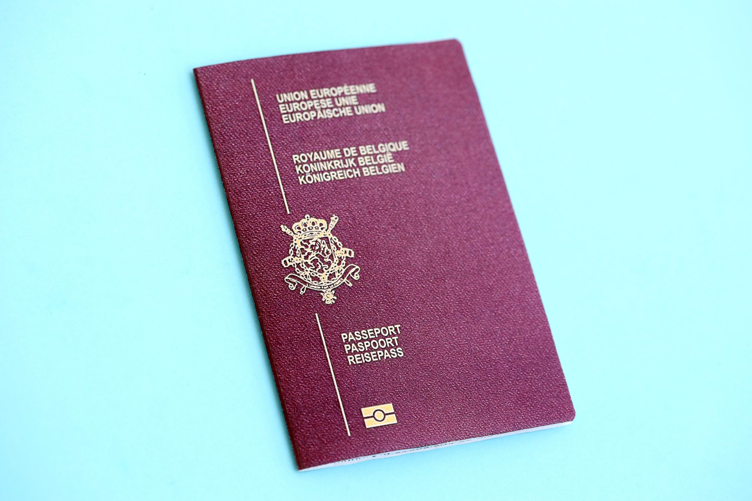 Belgium Passport On Light Blue Paper Background