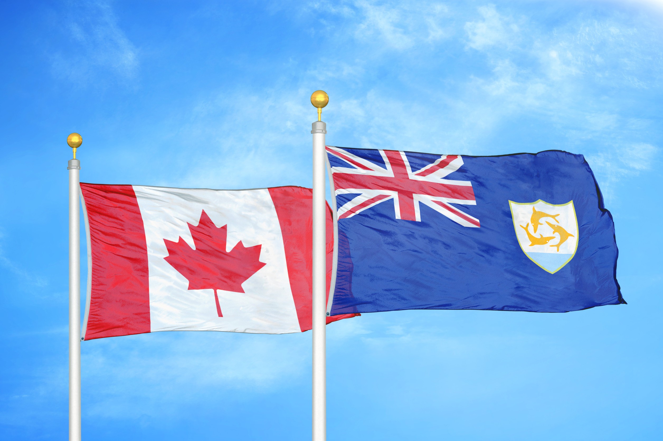 Canada And Anguilla Two Flags On Flagpoles And Blue