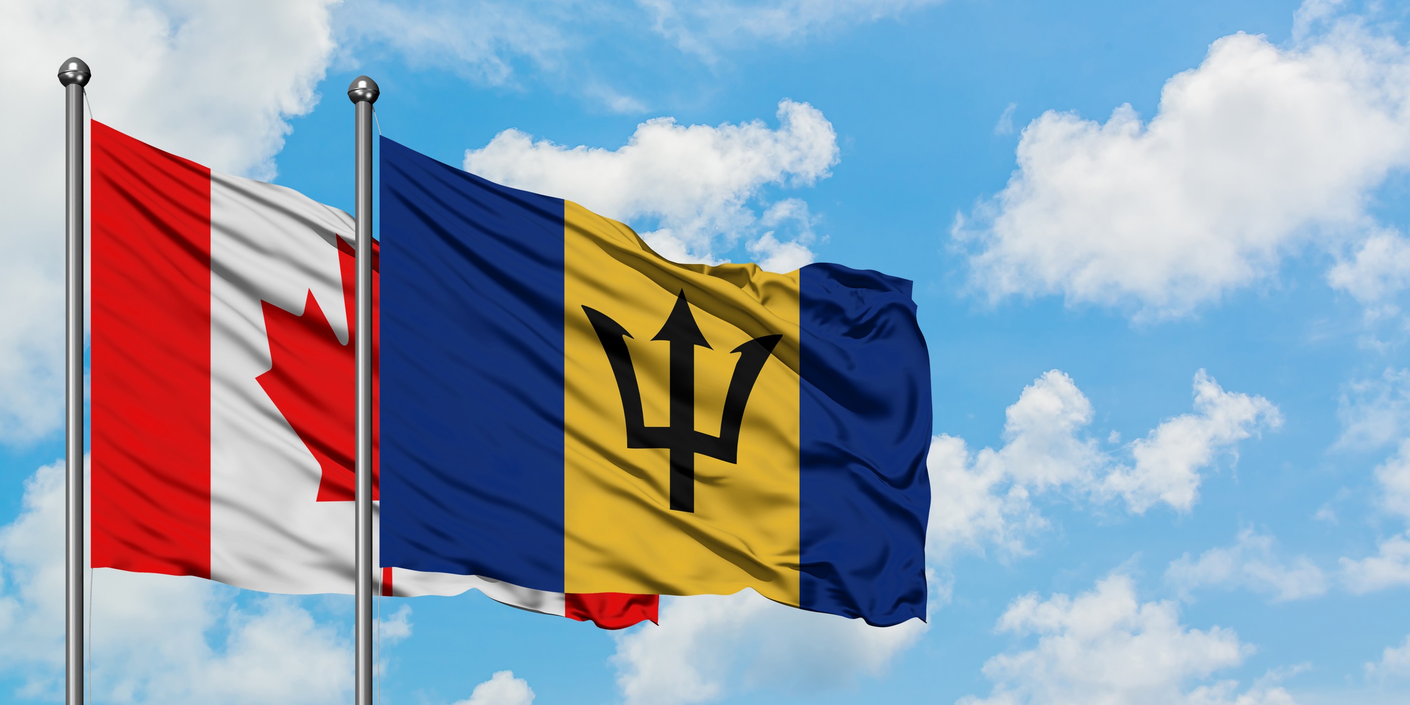 Canada and Barbados Flags Waving Together