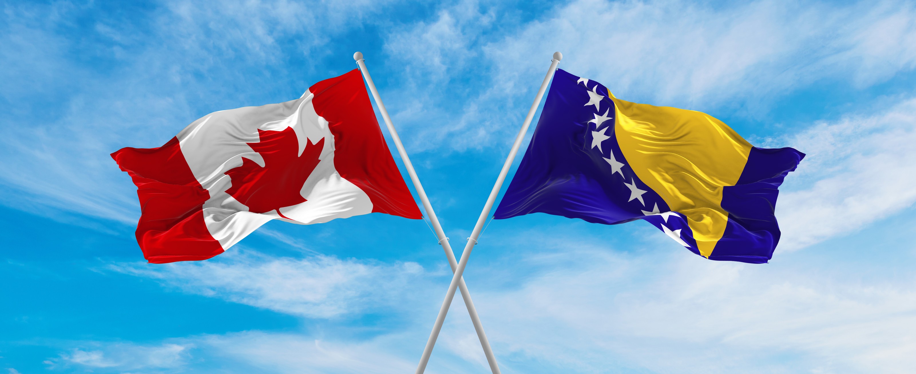 Canada And Bosnia And Herzegovina Flag Waving In The Wind At Cloudy