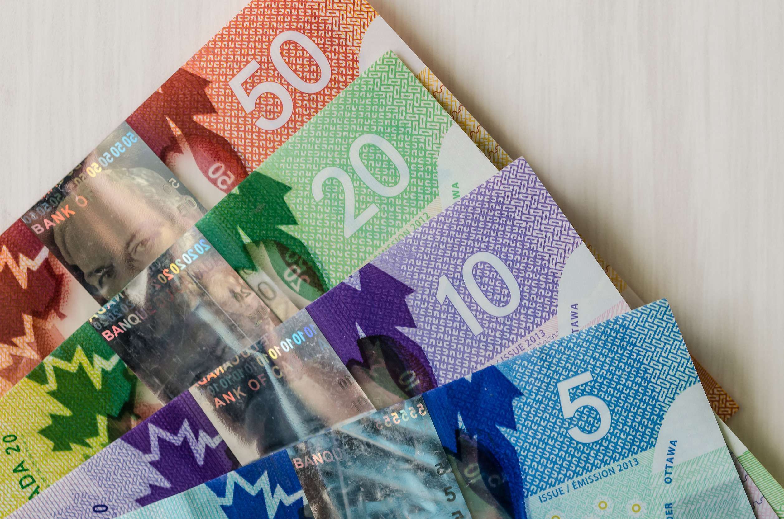 Canadian Dollar Banknotes On A Wooden Table
