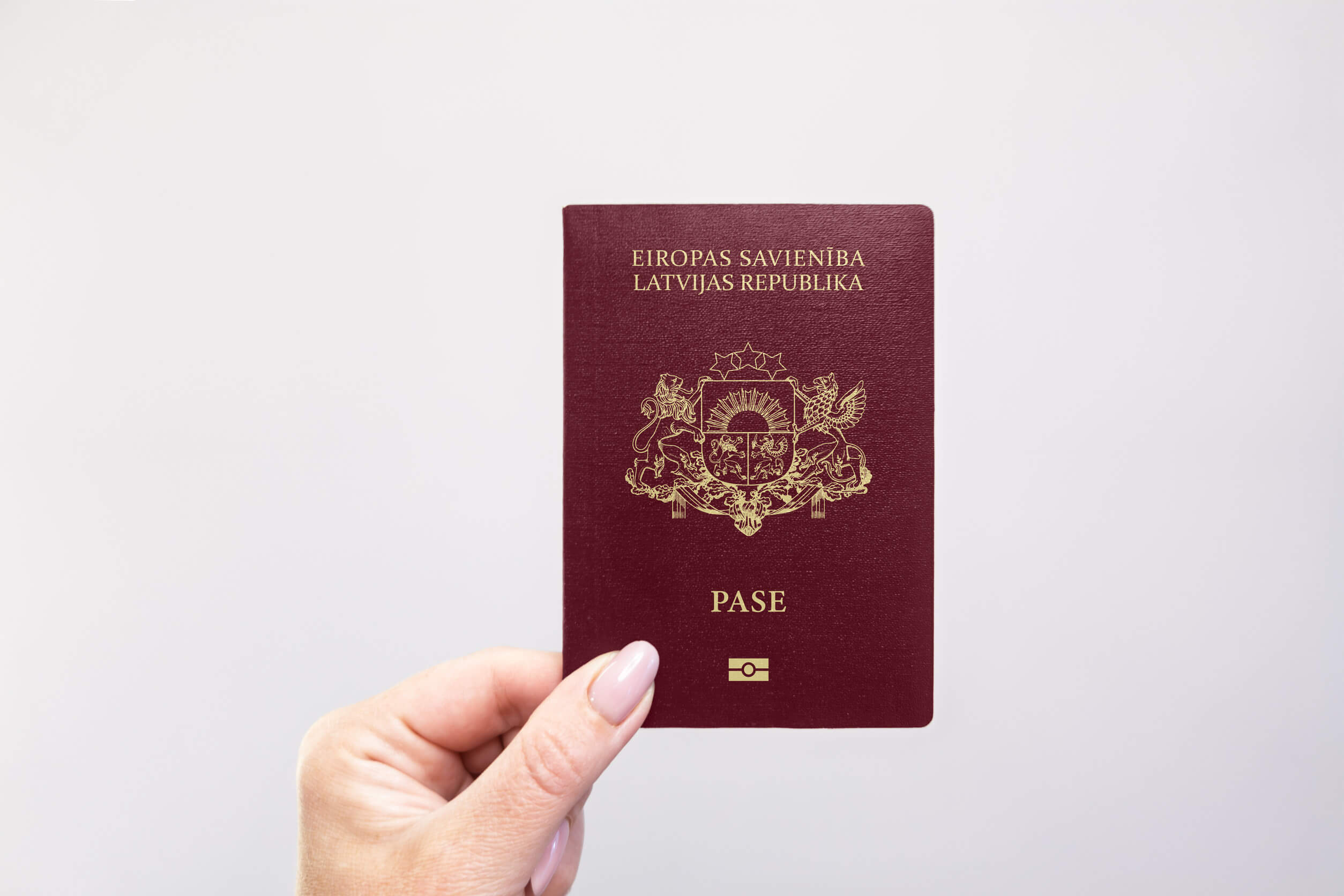 Close Up Of A Latvia Passport Held In Hand