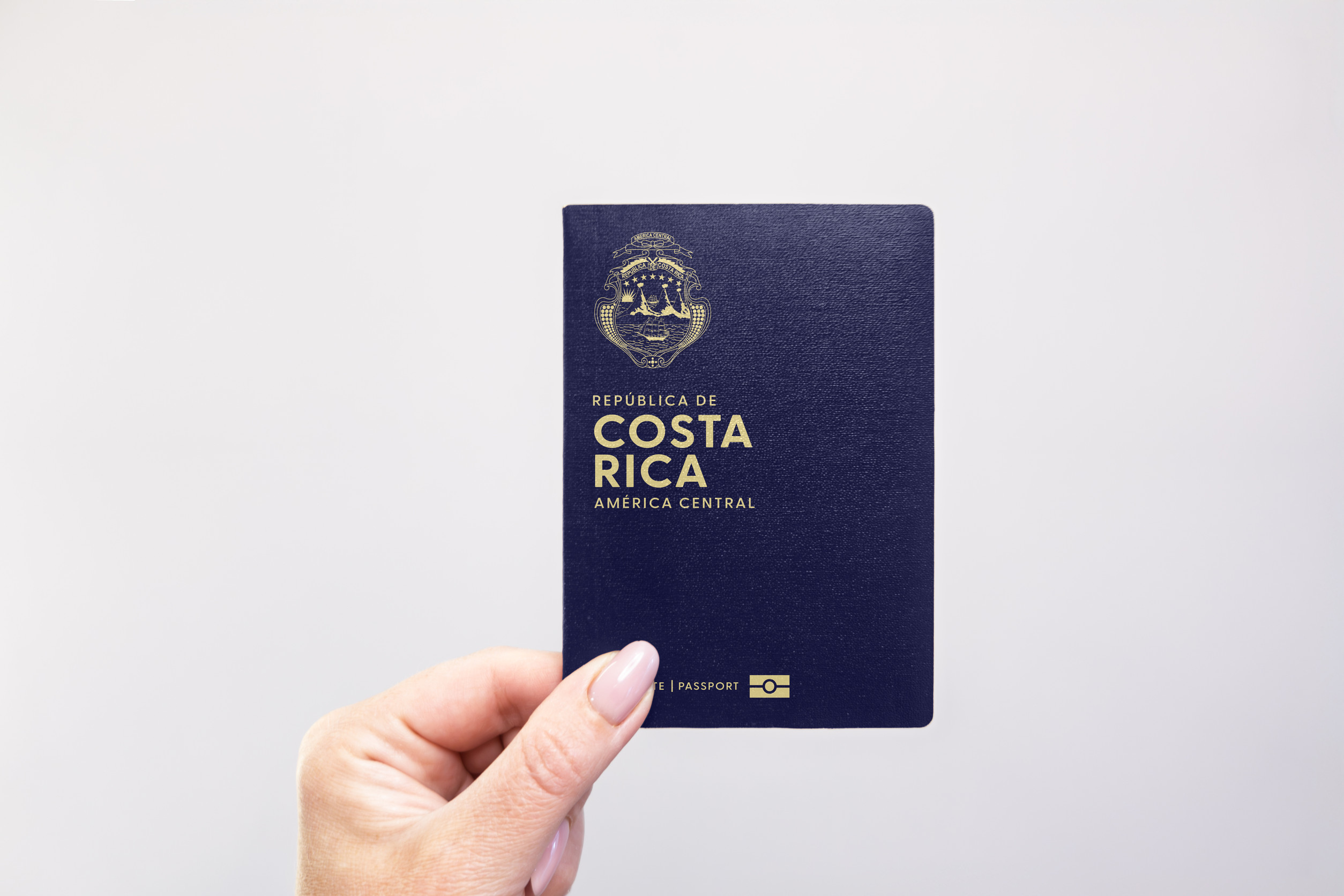 Costa Rica Passport Held In Hand Against A Plain