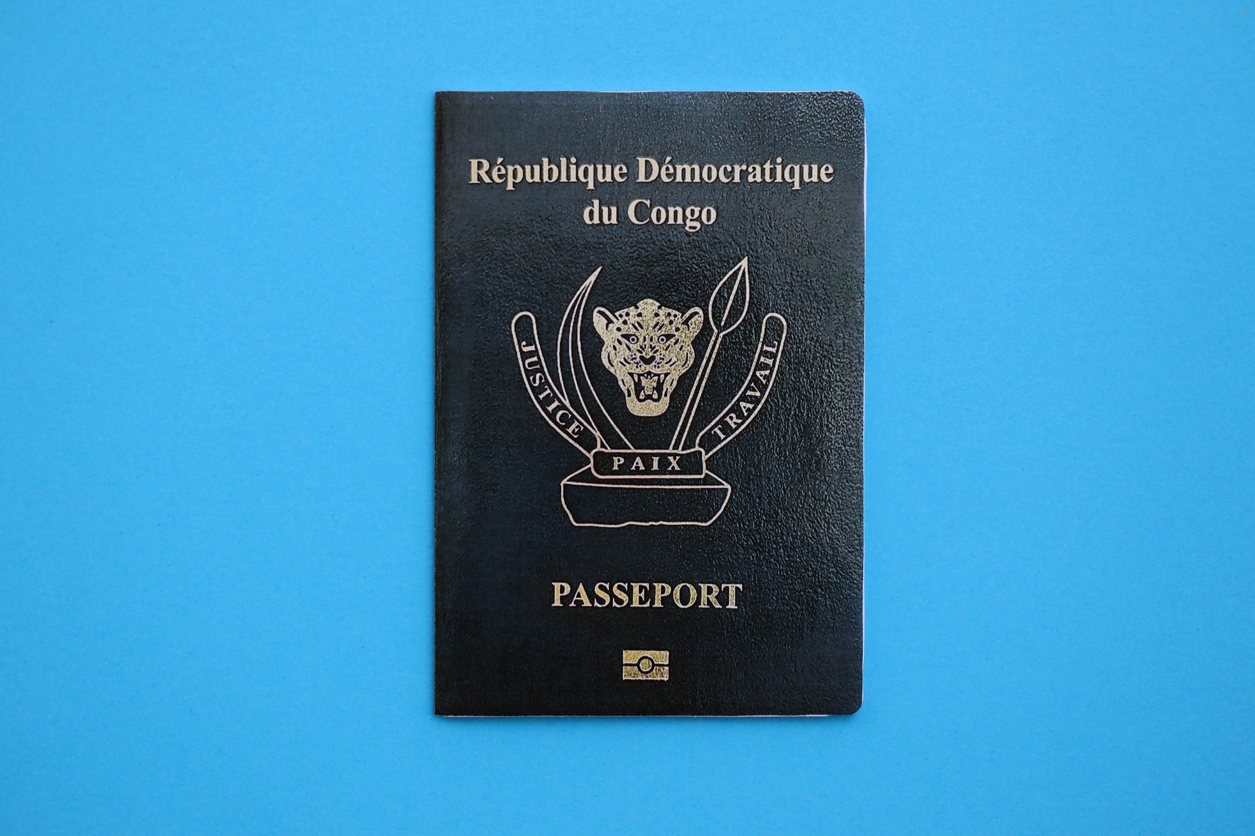 Democratic Republic Of Congo Passport On Light Blue Table Background