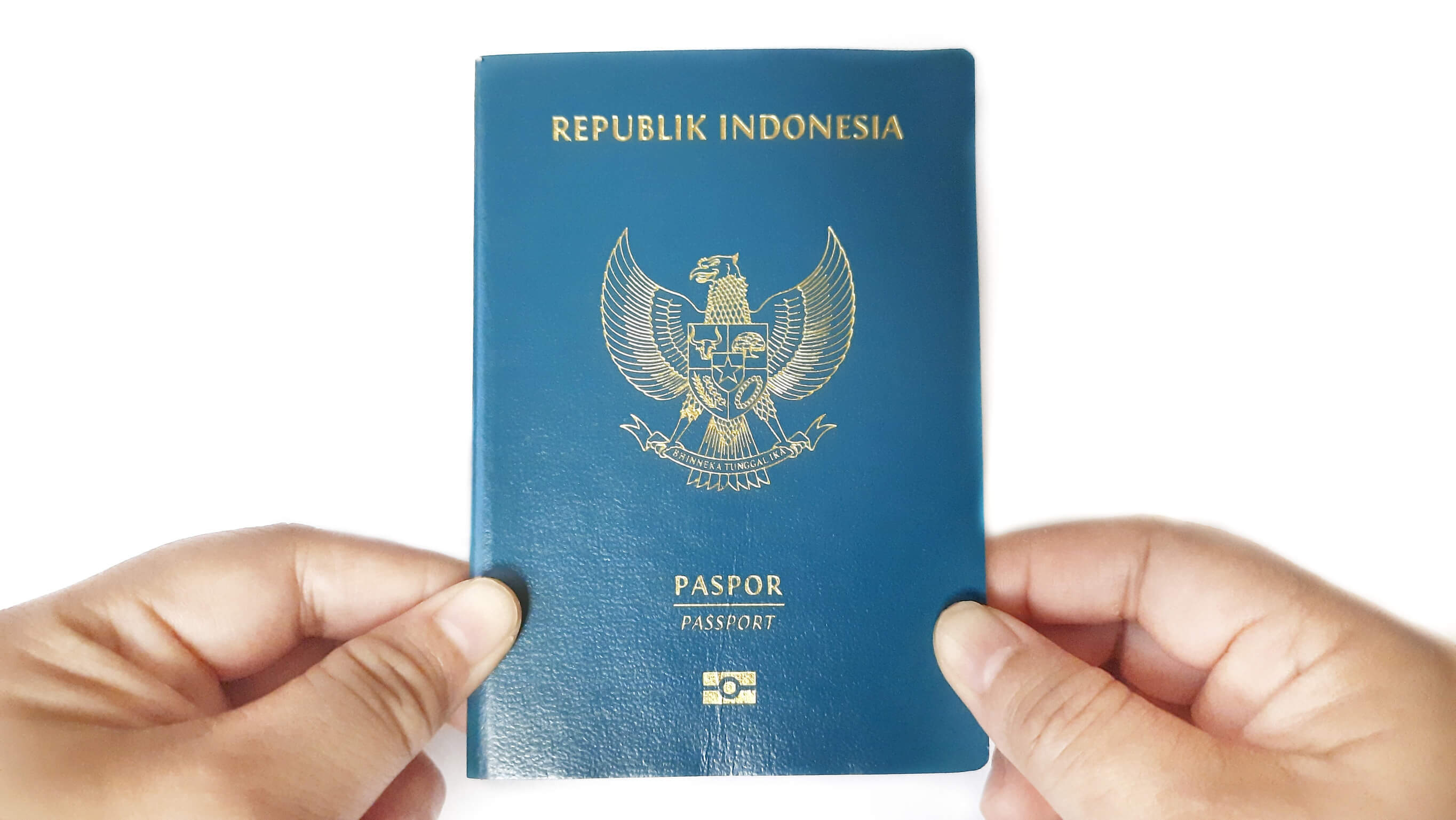 Hands Holding An Indonesian Passport