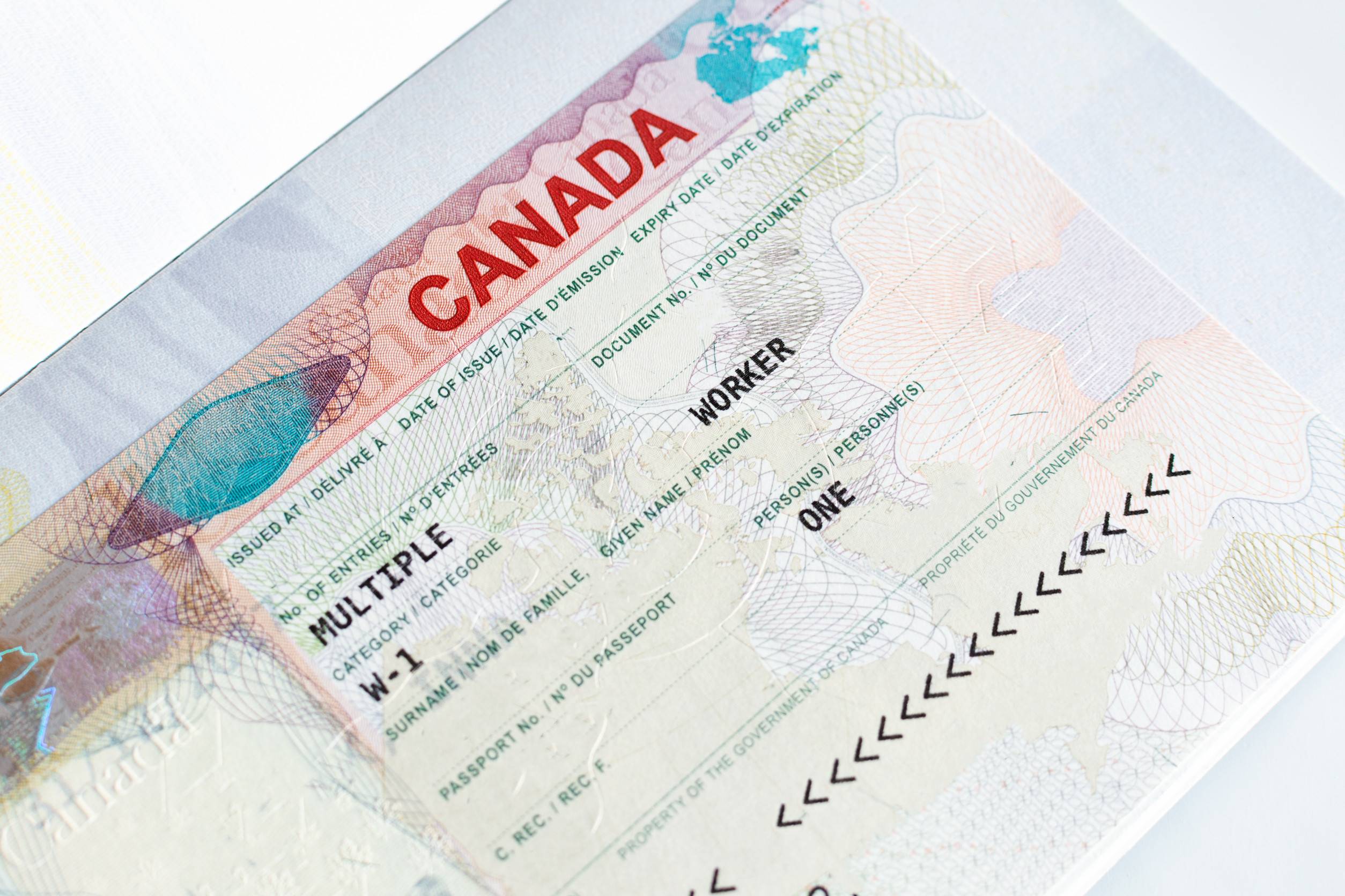 canadian working visa in passport closeup immigration to canada concept