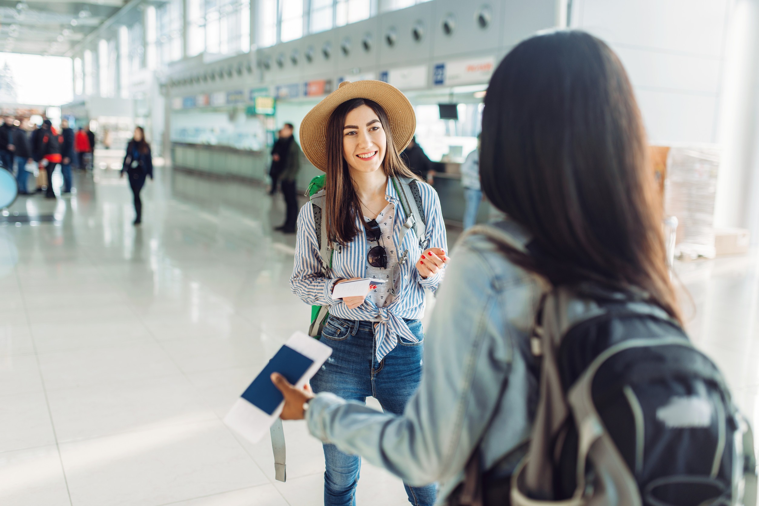 female tourists with bags in international airport