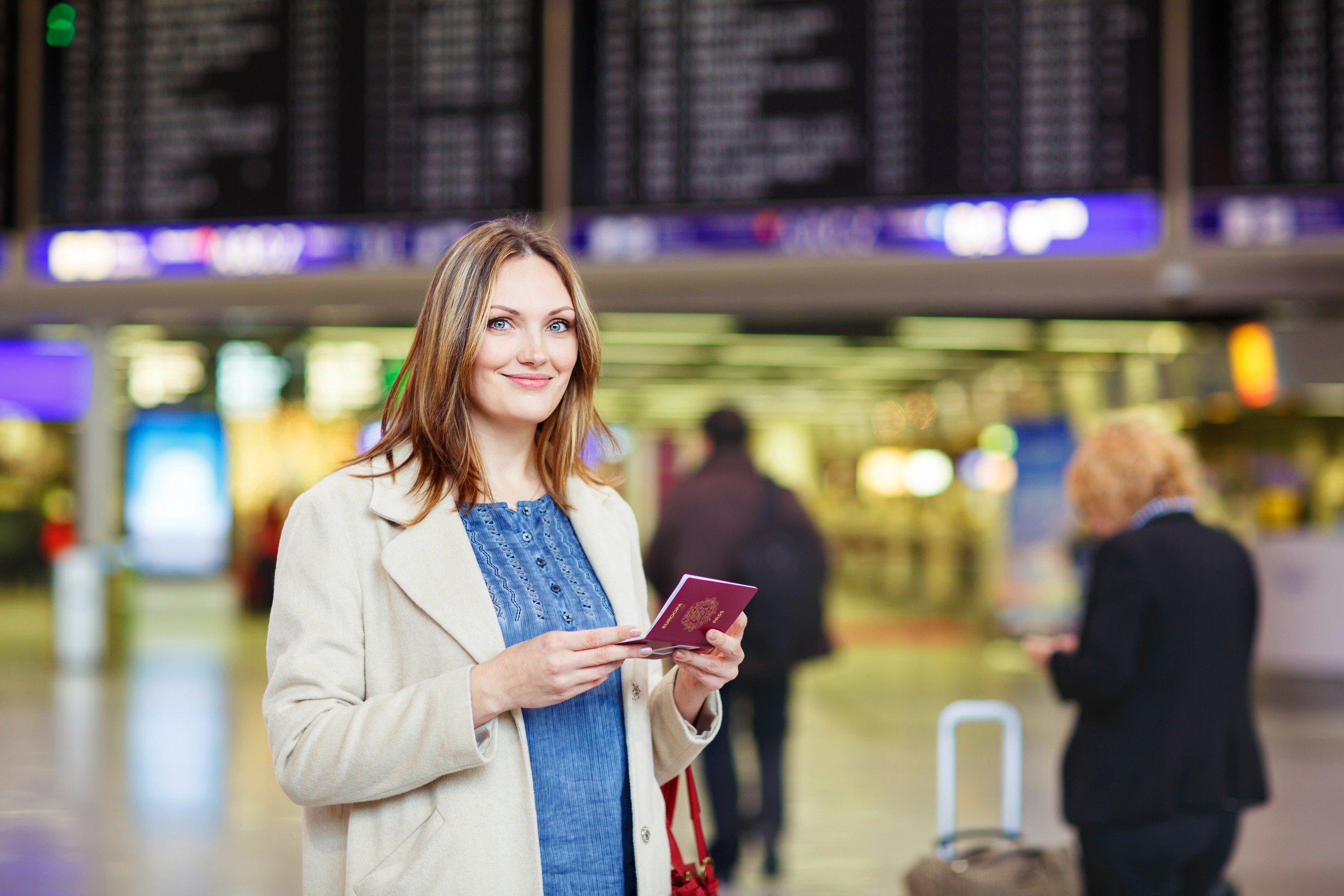 tired woman at international airport walking through terminal upset business passenger