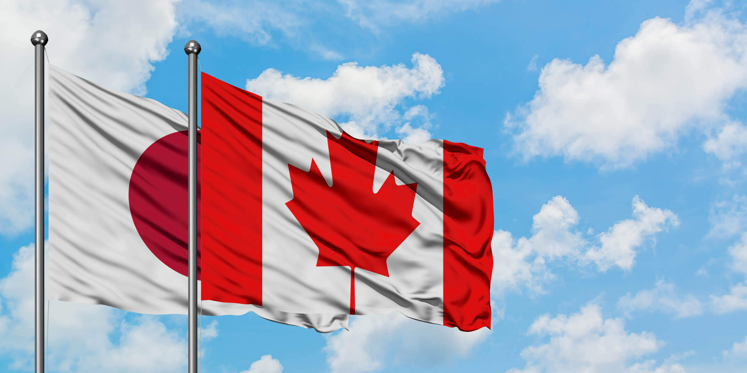 Japan And Canada Flag Waving In The Wind