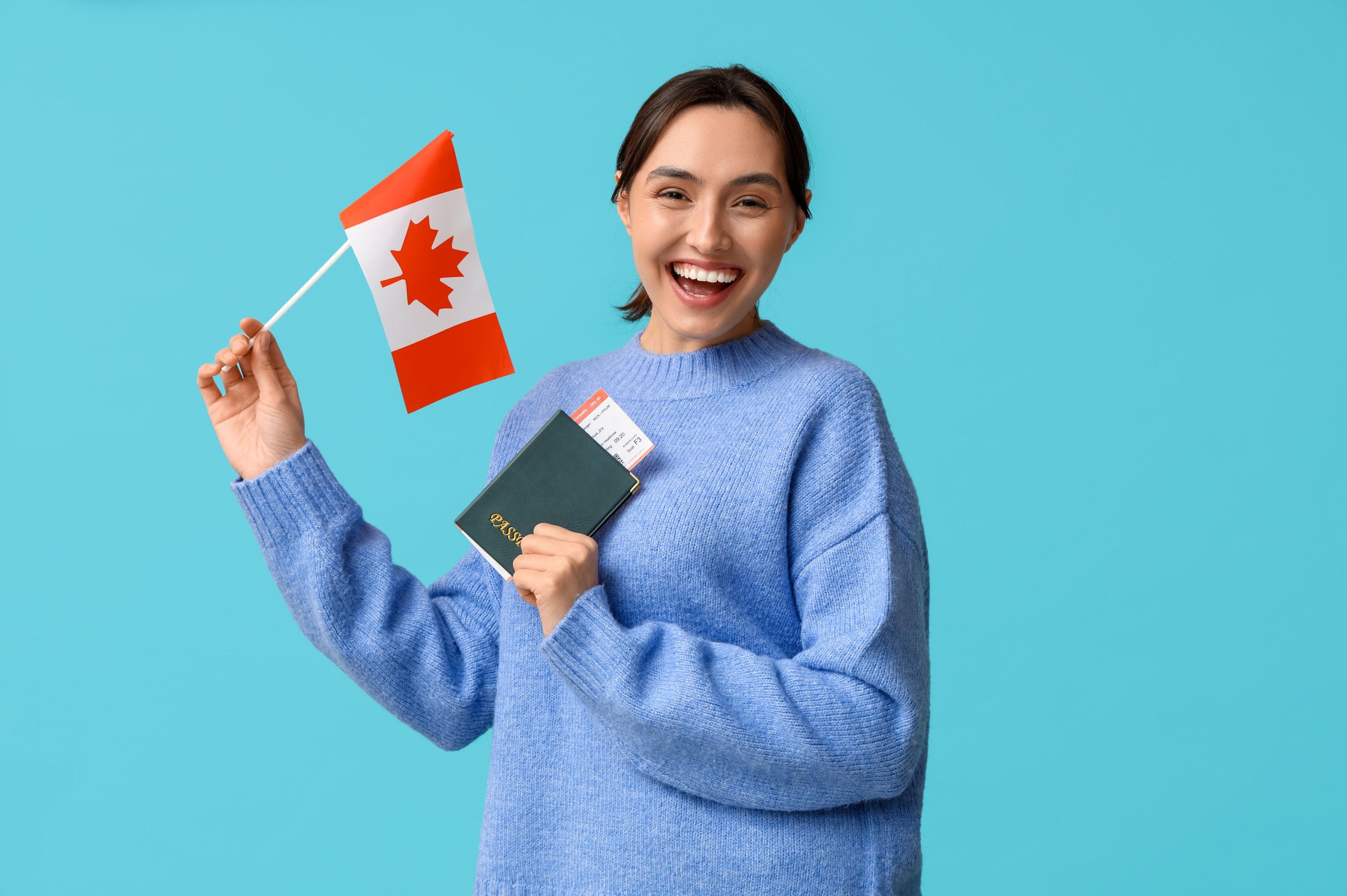 Pretty Young Woman With Flag Of Canada And Passport