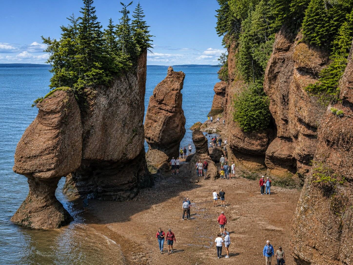 Travellers visiting Hopewell Rocks in Fundy National Park