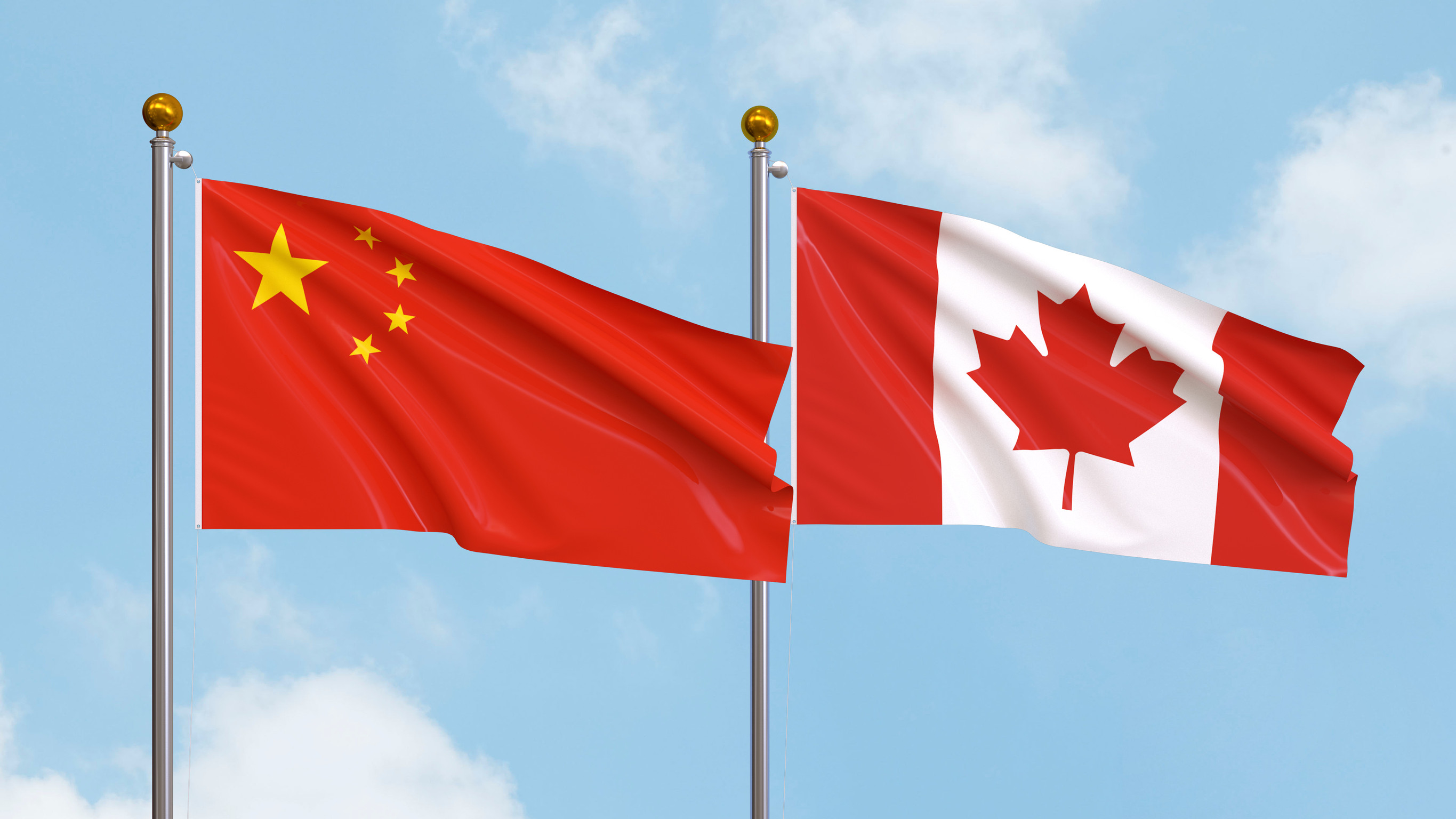 Waving Flags Of China And Canada On Sky Background