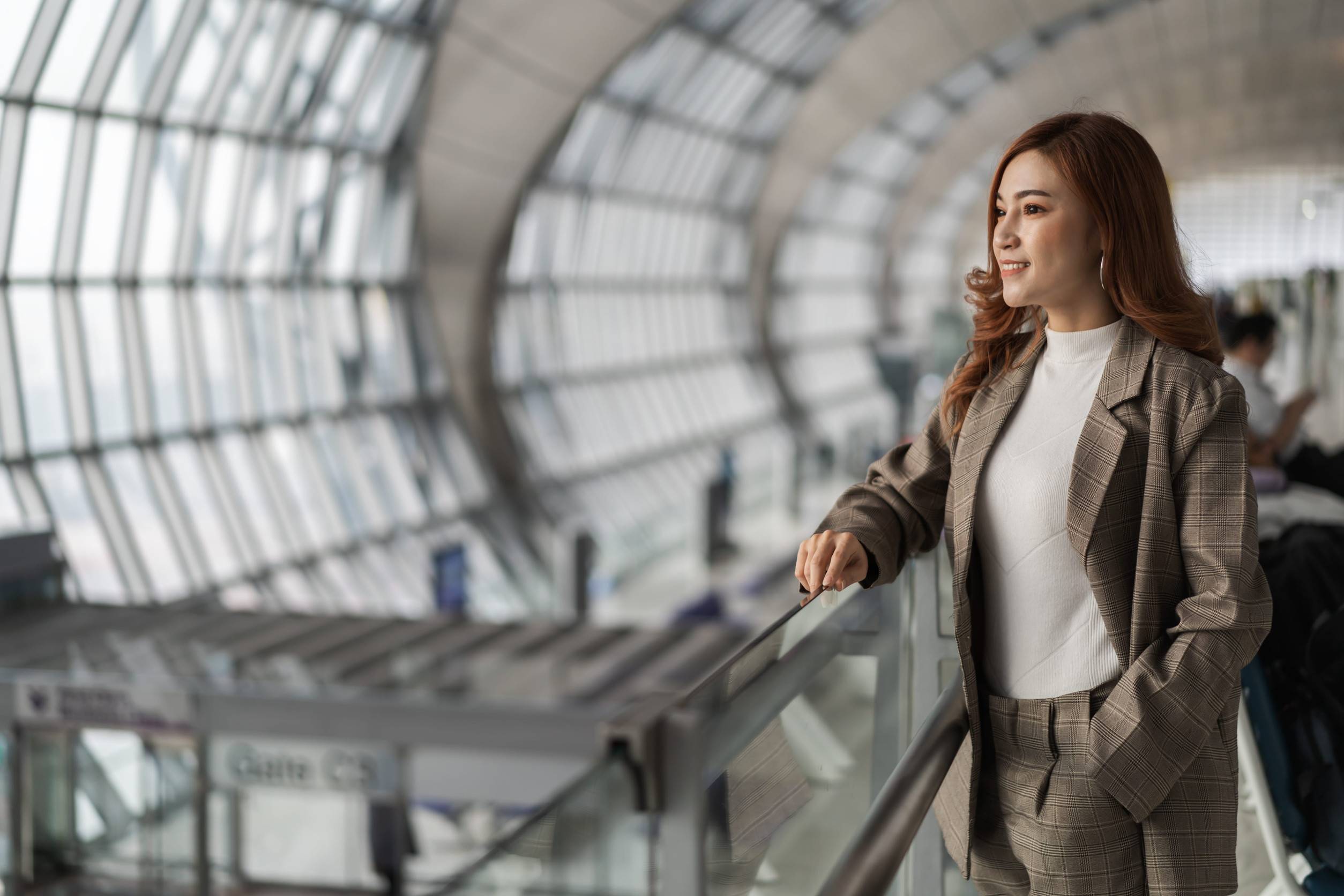Woman Waiting For Flight In Airport
